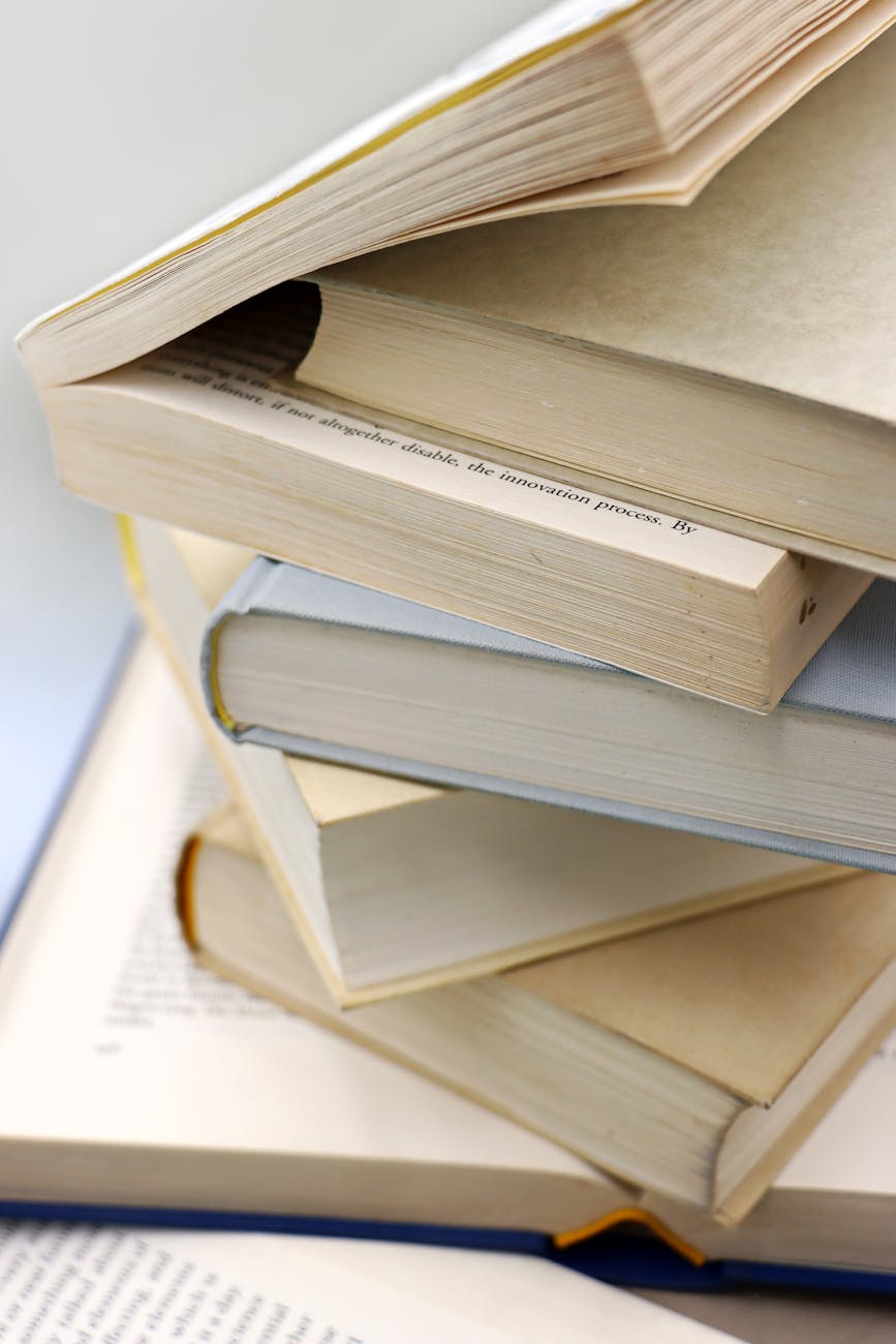 A close-up of a stack of open and closed books, perfect for learning and education themes.