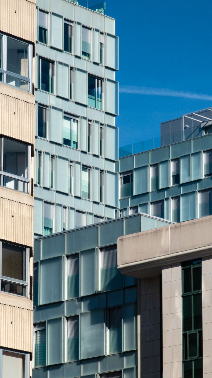 Contemporary urban architecture with modern buildings under a clear blue sky.