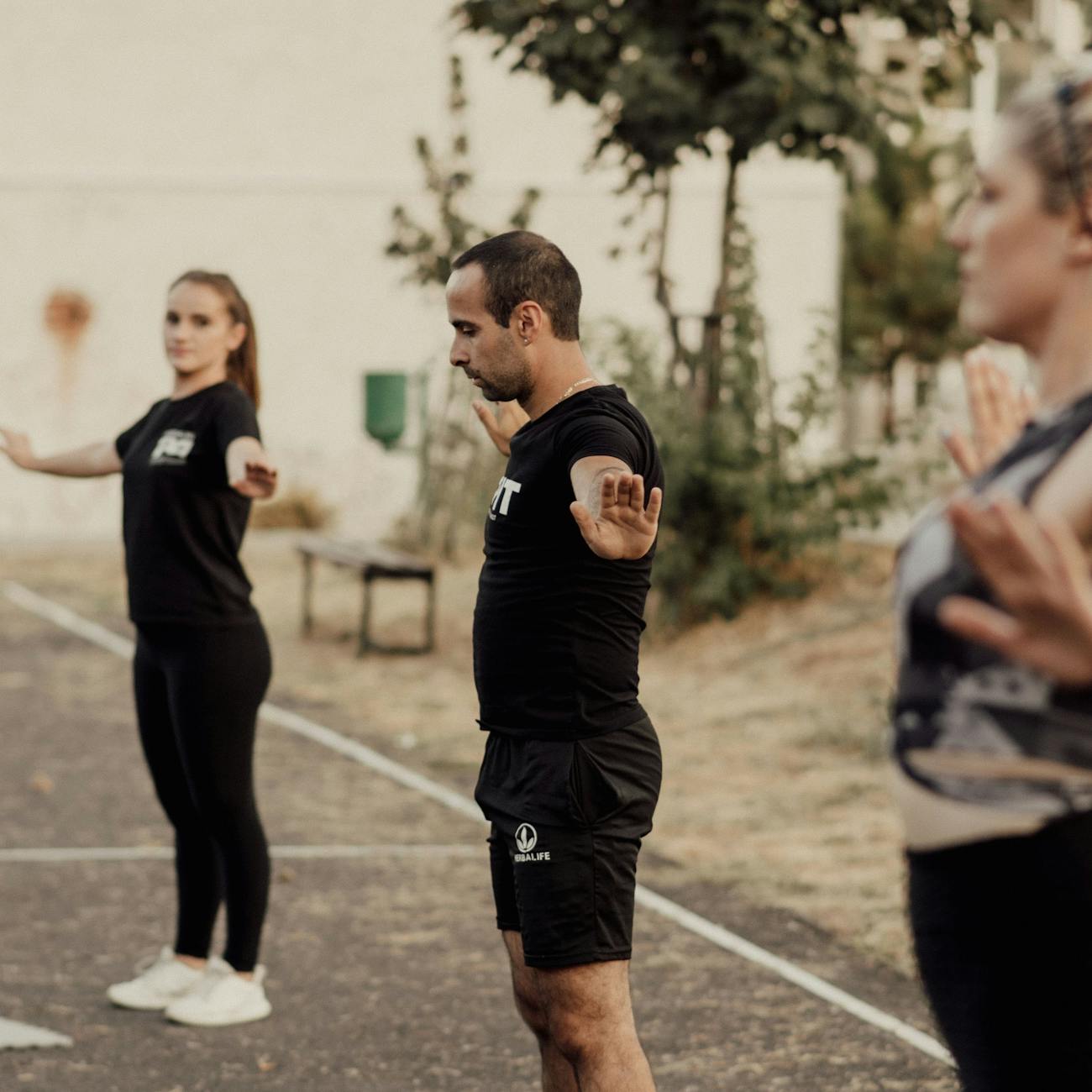 Adults engaging in outdoor fitness exercise in a park setting, staying active and healthy.