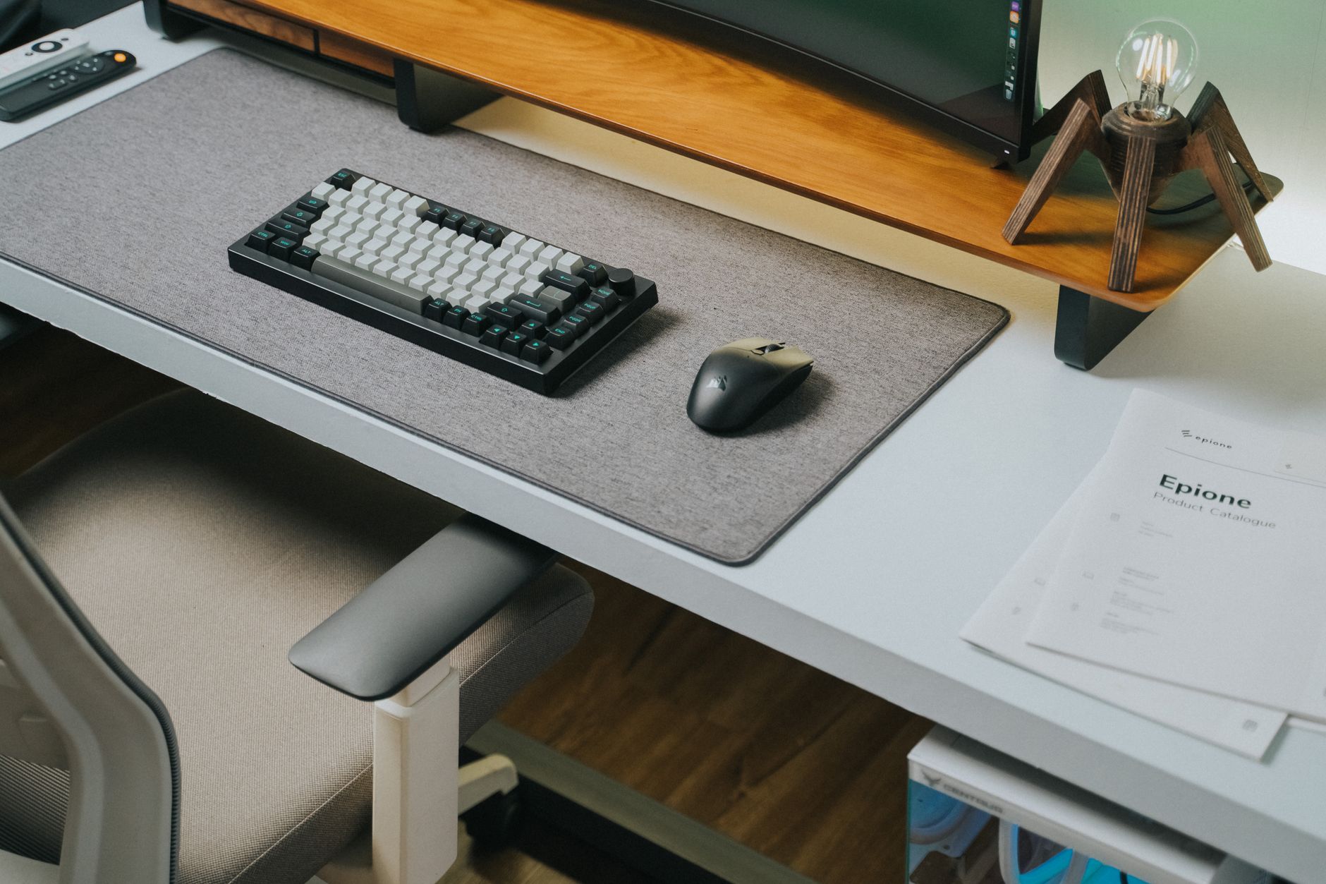 Sleek office desk with wireless keyboard, mouse, and modern decor, perfect for tech enthusiasts.