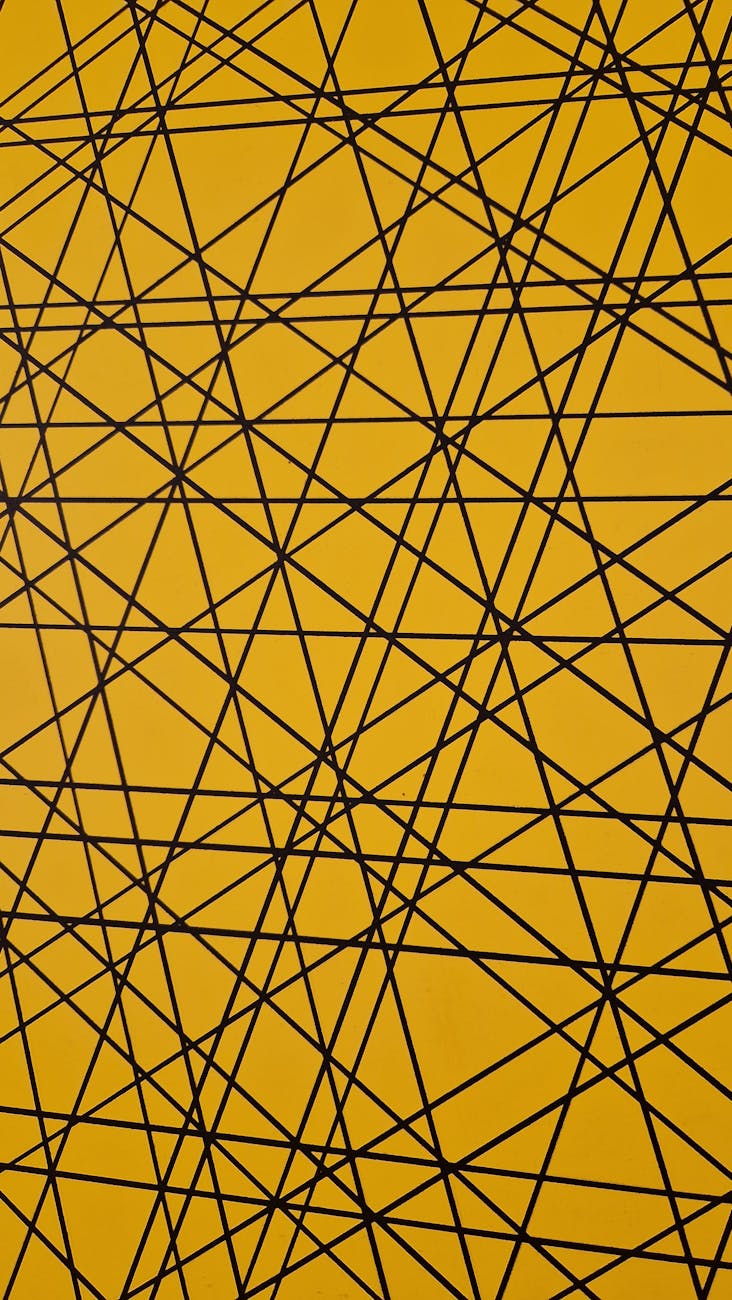 Dynamic abstract pattern of black geometric lines intersecting on a vibrant yellow background.