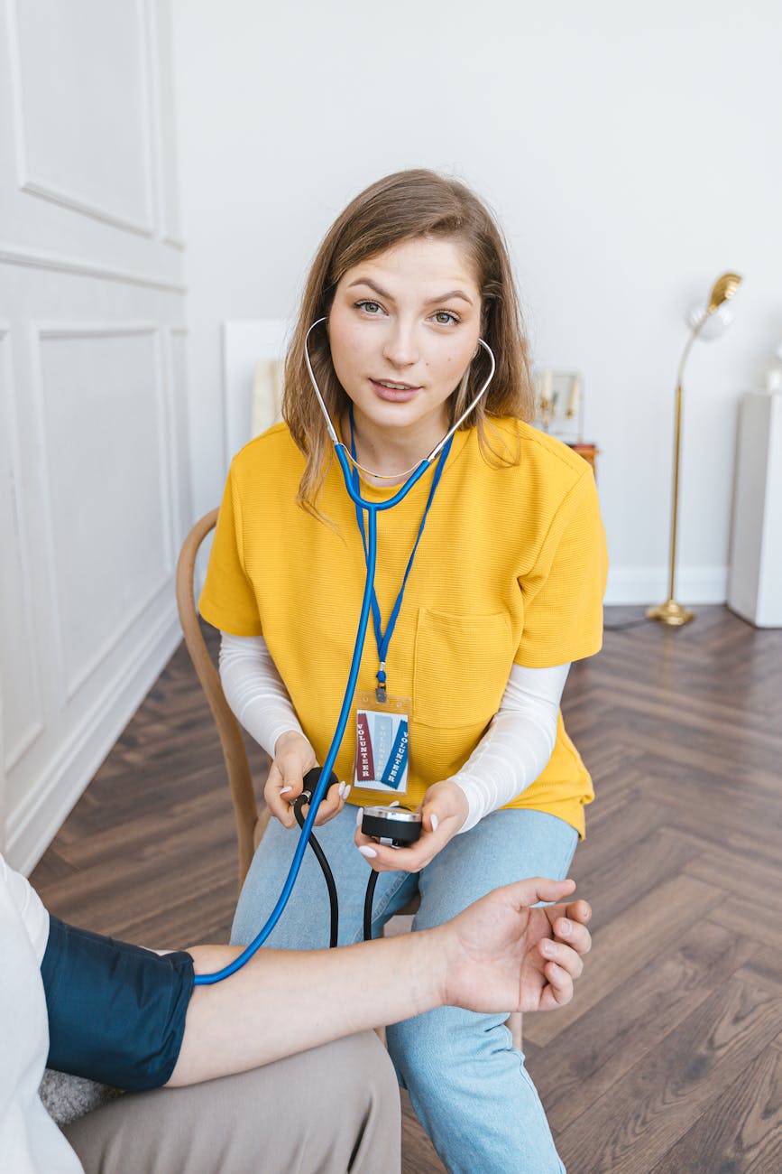 Medical professional checking patient's blood pressure in a clinical setting.