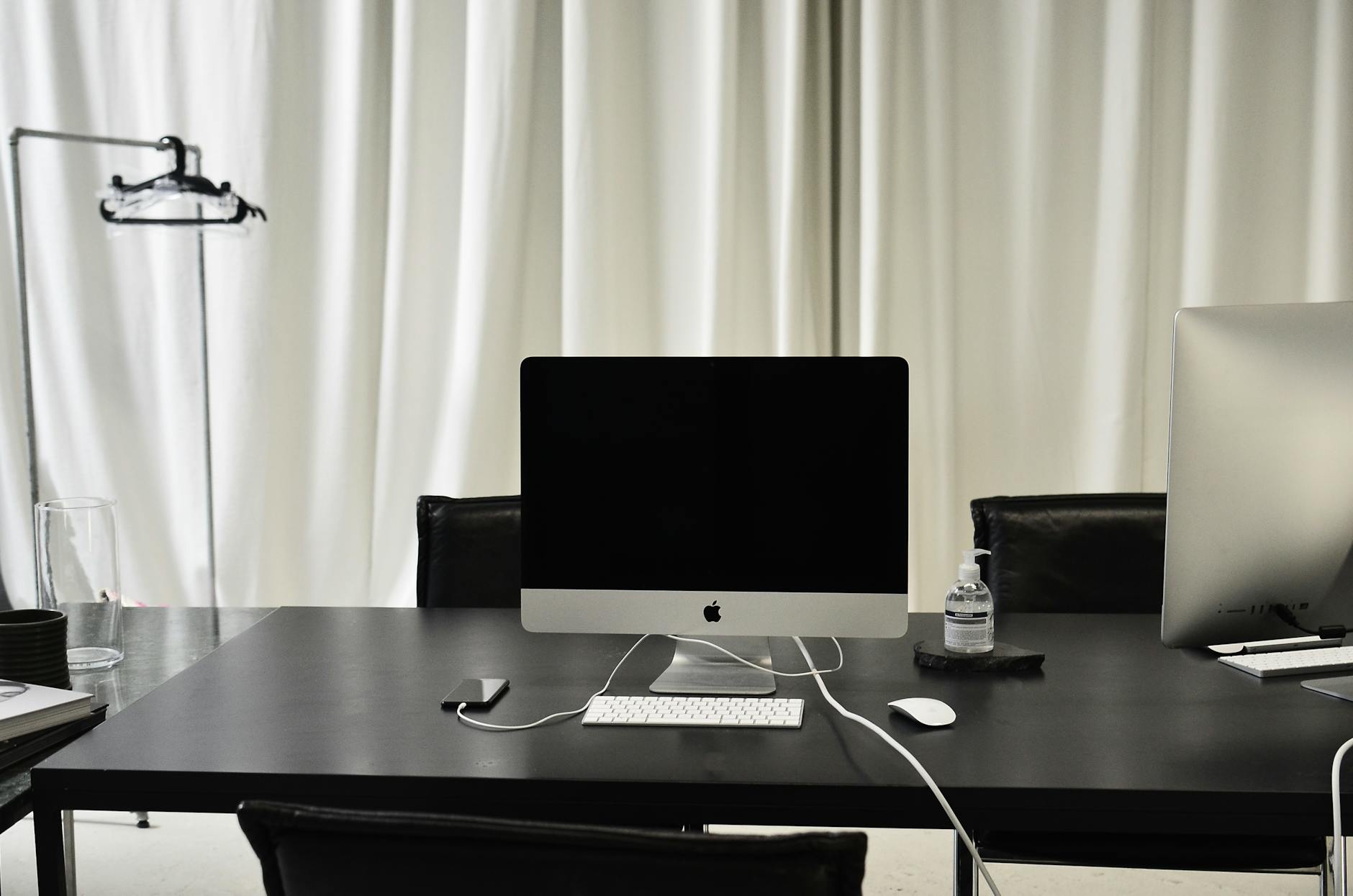Minimalist office setup featuring a sleek desktop computer and accessories.