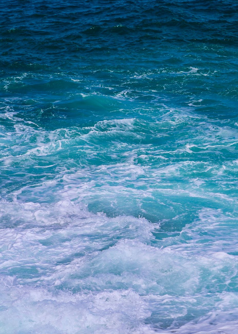 Dynamic ocean waves in vibrant blues and whites creating a perfect surf scene.