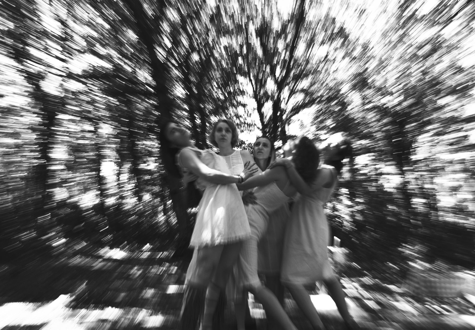 Artistic black and white photograph of women in a dynamic forest scene in Istanbul.