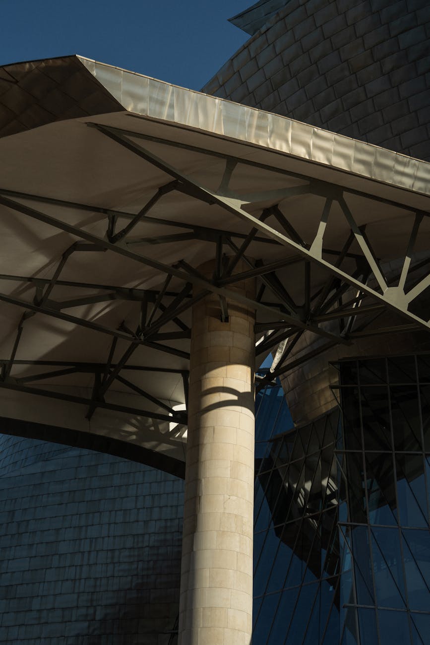 Close-up of modern architecture showcasing steel framework and glass reflections.