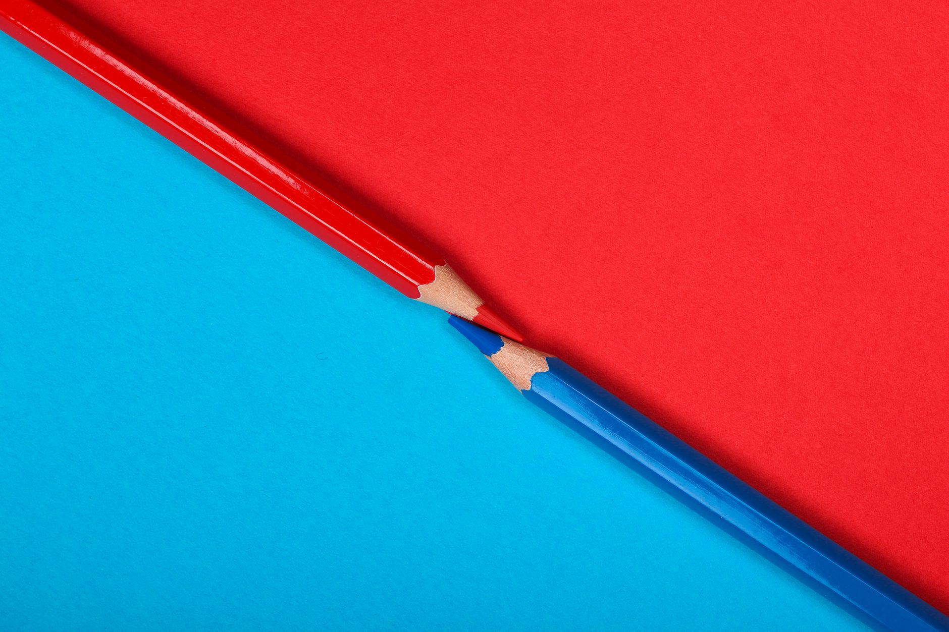 Sharp red and blue pencils on contrasting backgrounds, perfect for creativity and art themes.