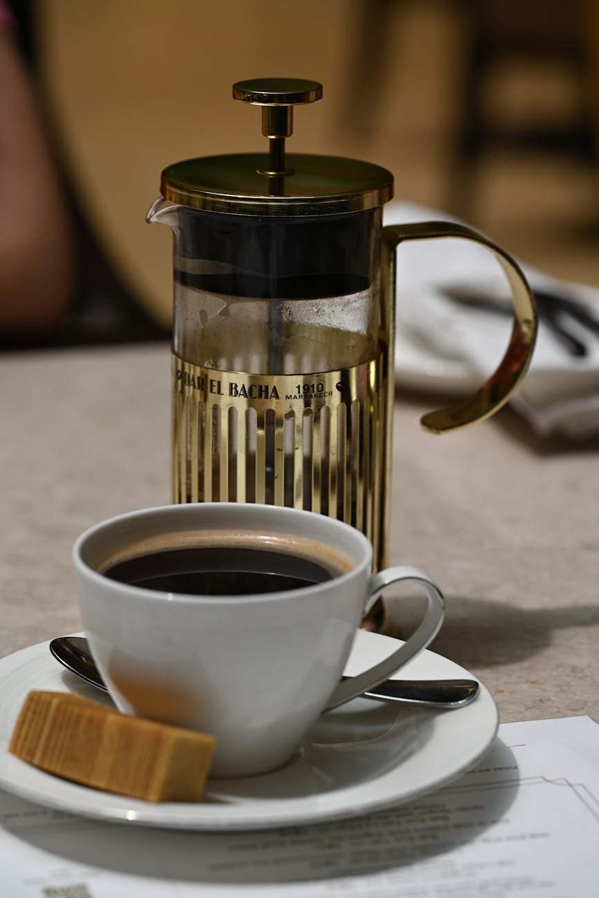 Close-up of French press coffee served in a stylish ceramic cup, perfect for coffee enthusiasts.