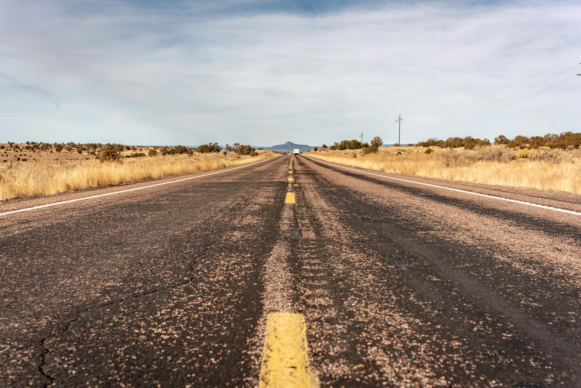 Long desert highway stretching into the horizon in Arizona, USA.