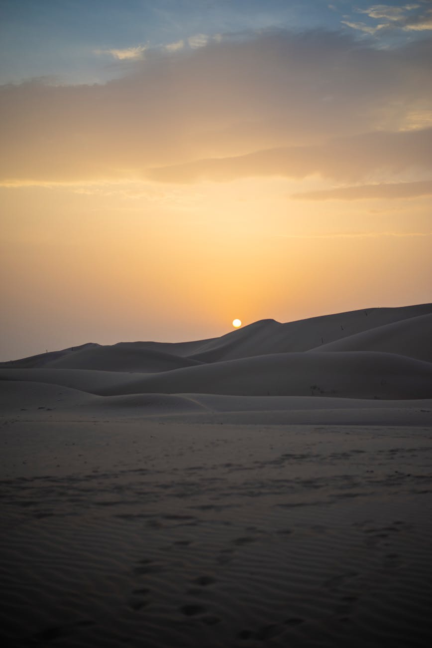 Captivating sunset over the dunes of Abu Dhabi desert, showcasing serene and arid beauty.