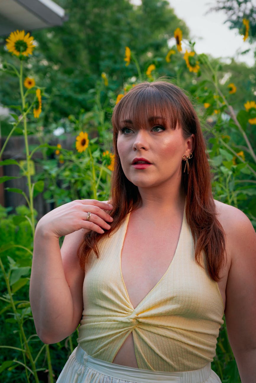 Chic summer fashion portrait of a woman in a sunflower garden, exuding a warm and elegant vibe.