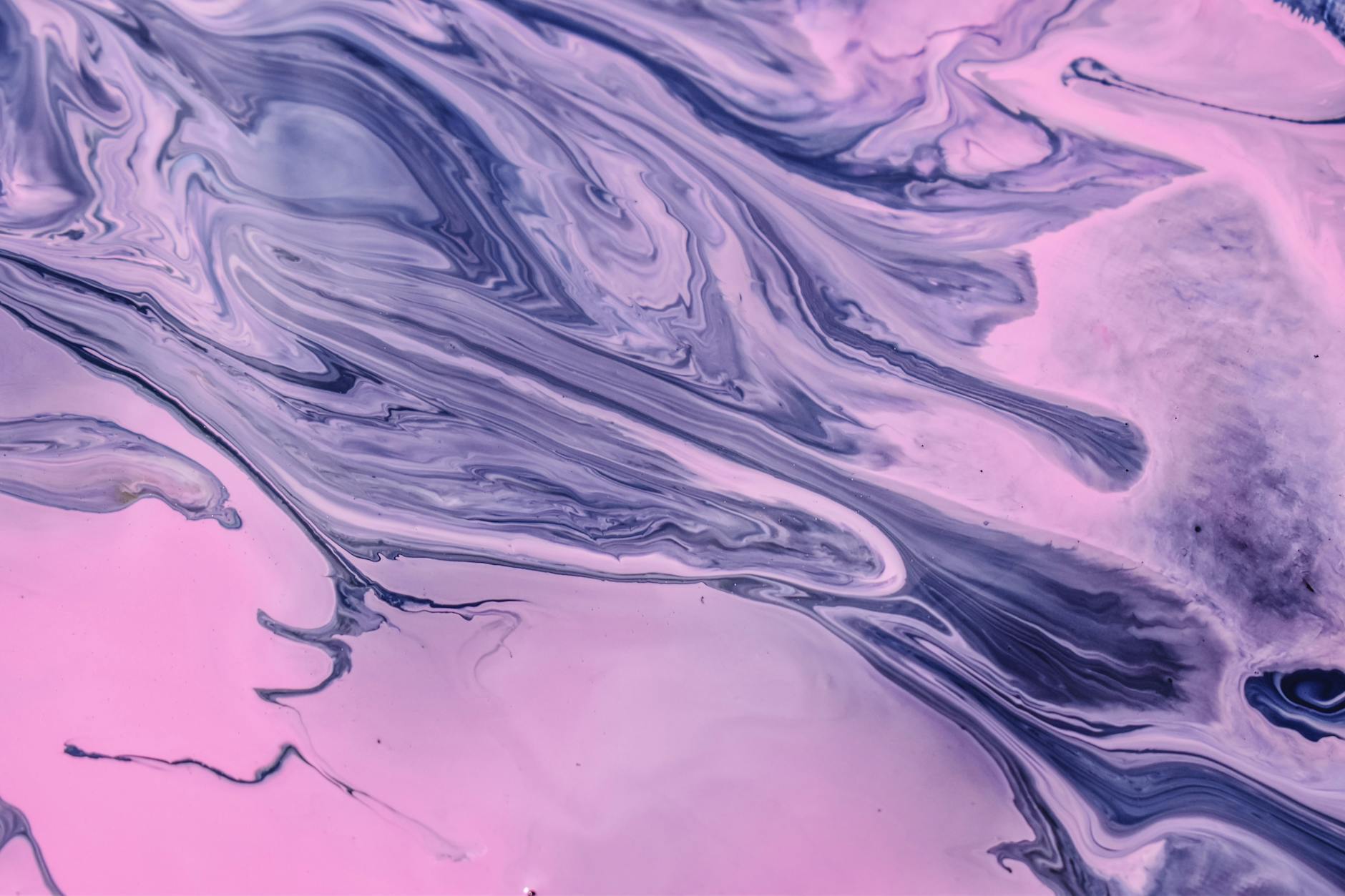 Swirling pink and purple fluid abstract art creates a vibrant and dynamic visual effect.