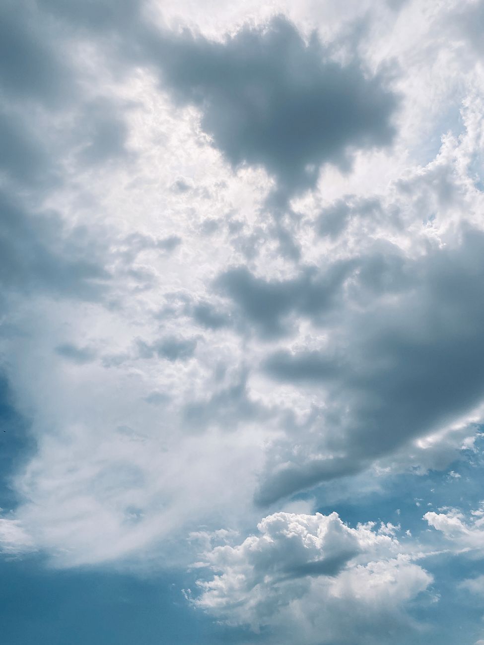 A beautiful cloudy sky with sunlight piercing through, creating a dramatic effect.