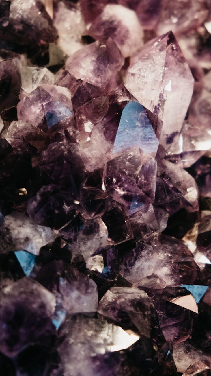 Stunning vertical shot of purple amethyst crystals. Perfect for wallpapers and artistic inspiration.