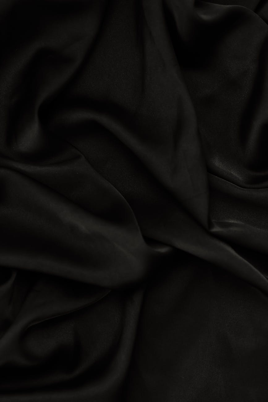 Rippled black textile with smooth texture, perfect for background use.